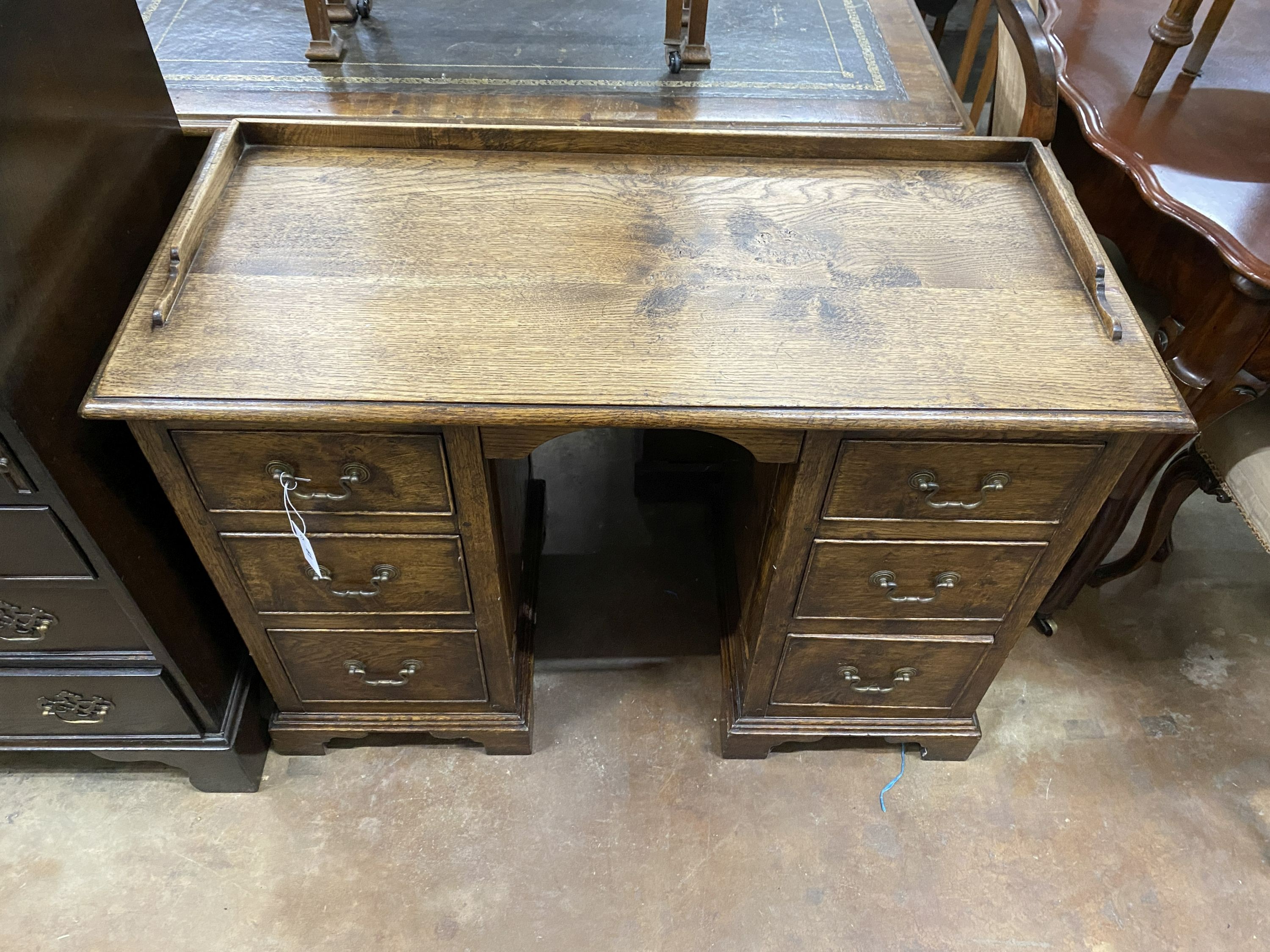 An 18th century style oak kneehole desk, width 103cm, depth 48cm, height 78cm